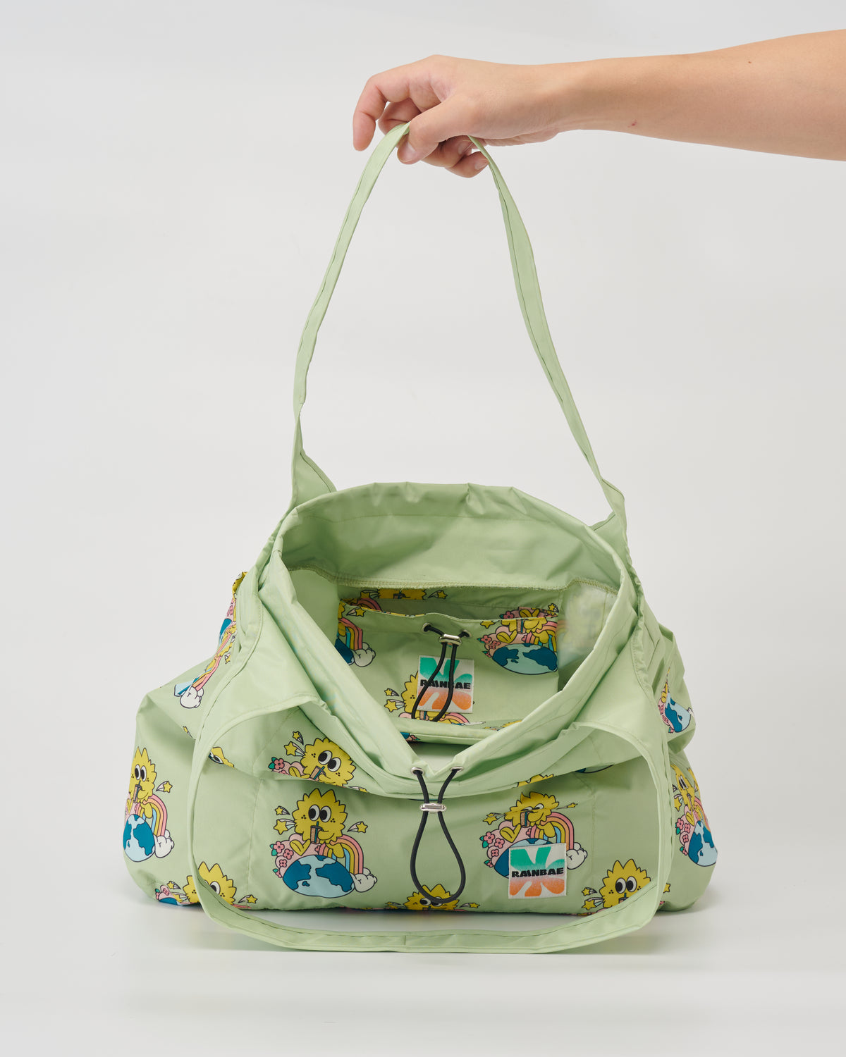 Inside view of the Sip and soar water-resistant tote bag in sage with inside folding pocket